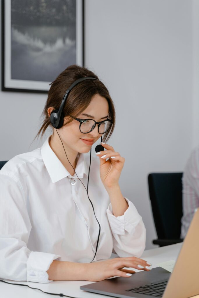 Professional woman using headset for customer service in office setting.